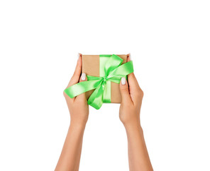 small gift box with green bow in female hand, isolated