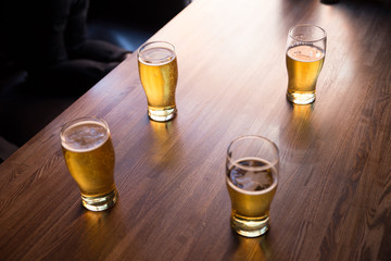 glasses of beer on the table in a bar or pub