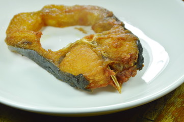 fried salty striped catfish slice on white dish