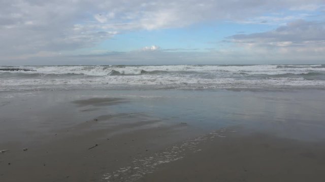 Waves rolling on the beach is a stormy day, winter mediterranean sea. Focene, Lazio, Italy. 4k