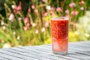 Mixed strawberry with ice and in tall glass.
