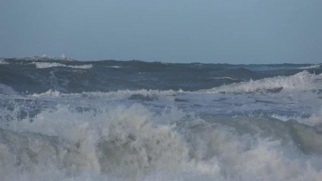 Waves rolling on the beach is a stormy day, winter mediterranean sea. Focene, Lazio, Italy. 4k