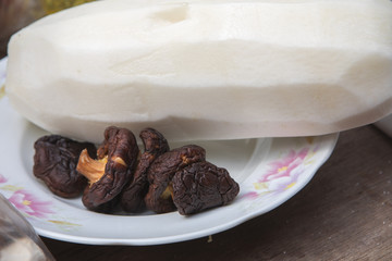 Traditional Chinese religious beliefs, devoted believers help to prepare ceremonial sacrifices, mushrooms and radish