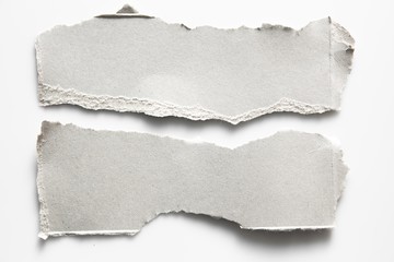 Brown corrugated texture paper torn on white background. rip of cardboard sheet used as a background .