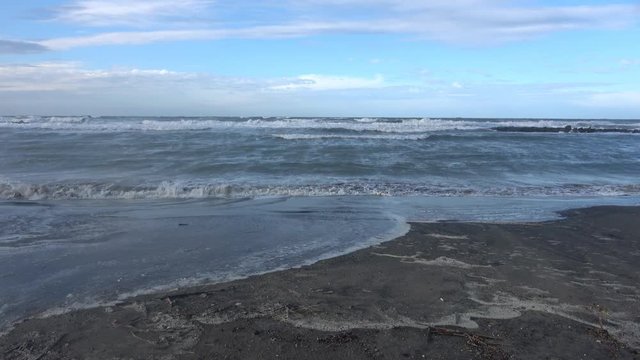 Waves rolling on the beach is a stormy day, winter mediterranean sea. Focene, Lazio, Italy. 4k