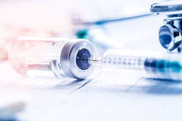 Medical syringe stethoscopeon  on the EKG graph.
