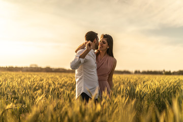 Romantic Couple on a Love Moment at gold wheat field - Holambra, Sao Paulo, Brazil