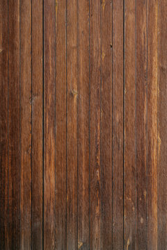 Vertical grungy ancient wooden planks in Spain. Wooden dark brown texture