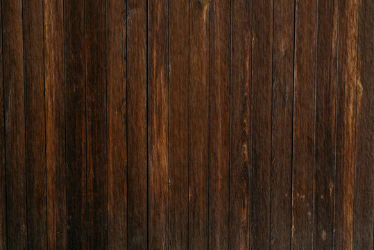 A lot of grungy ancient wooden planks in Spain. Wooden dark brown texture
