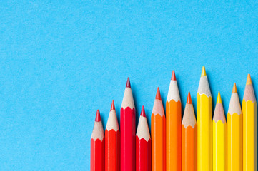 Color pencils isolated on blue background.


