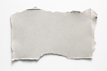 Obraz premium Brown corrugated texture paper torn on white background. rip of cardboard sheet used as a background .