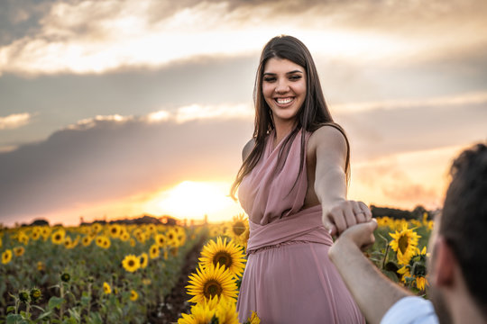 Boyfriend holding hands and asking Marry me for Girlfriend in a field of flowers