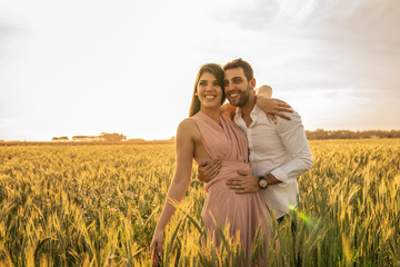 Naklejka na ściany i meble Romantic Couple on a Love Moment at gold wheat field - Holambra, Sao Paulo, Brazil