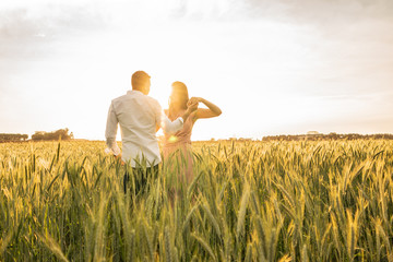 Romantic Couple Dancing on Love Moment at gold wheat field 