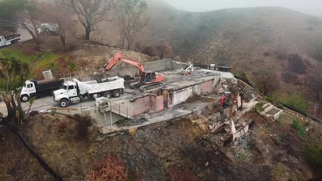 Aerial of a house being bulldozed on a hillside in Ventura following the destruction of Thomas Fire.