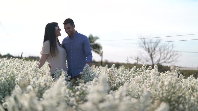 Romantic Couple on a Love Moment in a field of flowers