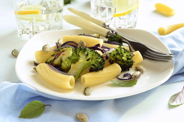 Pasta with roasted broccoli, purple onions and pumpkin seeds