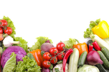 a variety of fresh vegetables including tomato pepper cabbage beetroot zucchini and carrot leaves garlic and cucumber salad on white isolated background