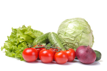 Fresh vegetables including a lettuce tomato cabbage onions onions isolated on white isolated background