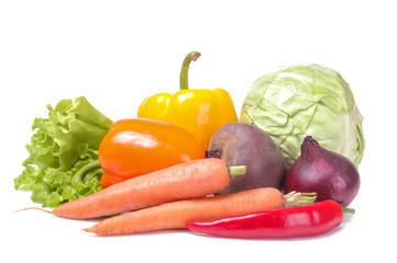 Fresh vegetables including cabbage lettuce onions pepper beetroot carrots on white isolated background