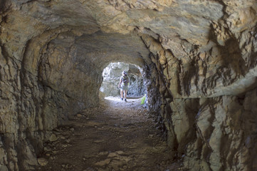 woman walking inside a tunnel of the Road of 52 galleries, Veneto, Italy