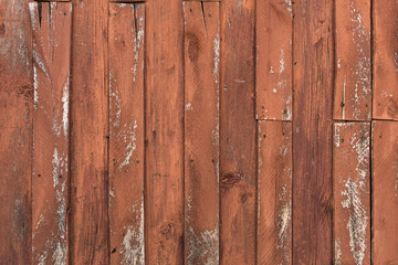 old wooden door with peeling and cracked red paint