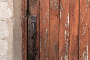 old wooden door with peeling and cracked red paint