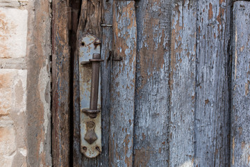 old wooden door with peeling and cracked grey paint