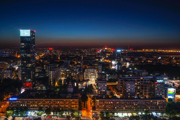 Stunning panoramic view of a vibrant city skyline at night in Warsaw, Poland