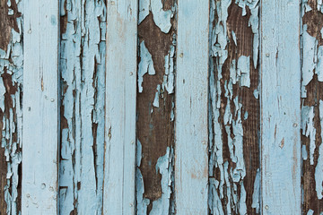 old wooden door with peeling and cracked white paint