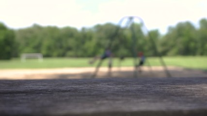 Kids playing on a swing set out of focus