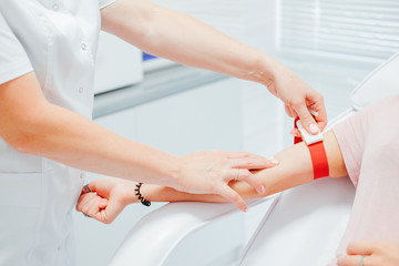 Nurse taking blood sample from the patient