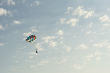 Round parachute against the sunset sky with clouds in an unusual color scheme. Multi-color process.
