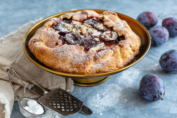 Homemade pie with plums,cinnamon and almond flakes.