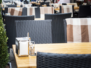 View of empty tables in outdoor cafe on the street european street