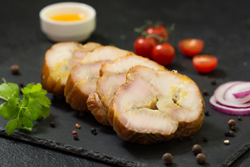 Fish sturgeon on the black wooden table