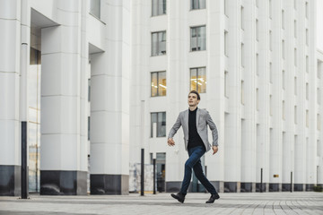 Distant plan of happy man going to or from work and dancing.