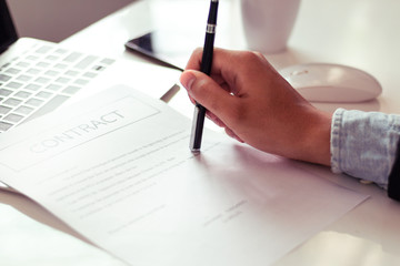 Businessman reading documents in office.