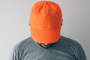 Man wearing orange baseball cap for mockup