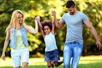 Happy young couple spending time with their daughter