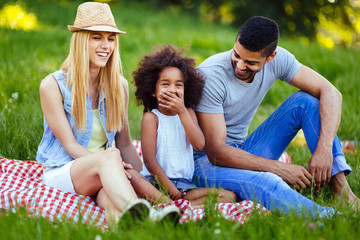 Picture of lovely couple with their daughter having picnic