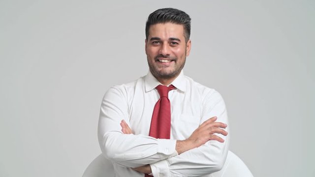 Confident businessman portrait in white background. Young indian man in white shirt and red tie pose confident smile to camera. Young businessman concept.