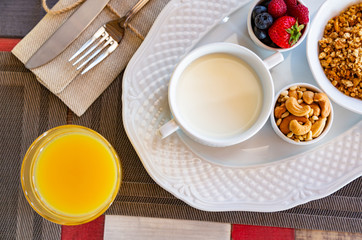 Healthy breakfast. Fresh juice, granola, muesli with milk and berries