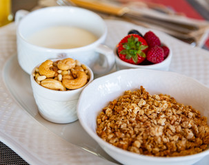 Healthy breakfast. Fresh juice, granola, muesli with milk and berries