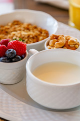 Healthy breakfast. Fresh juice, granola, muesli with milk and berries
