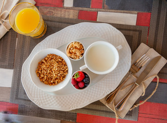 Healthy breakfast. Fresh juice, granola, muesli with milk and berries