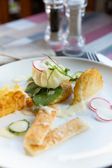 Healthy breakfast food. Delicious benedict for real gourmet. Beautifully served benedict on white tray in restaurant.