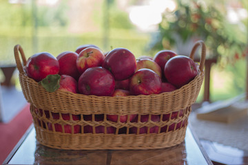 red organic apples in a beautiful basket