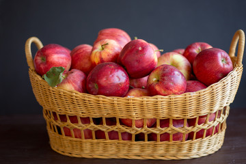 Fototapeta na wymiar red organic apples in a beautiful basket