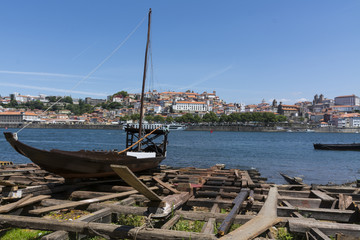 Shipyard with a traditional cargo boat, and Porto in the background